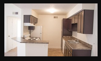 a kitchen with a stove and a refrigerator